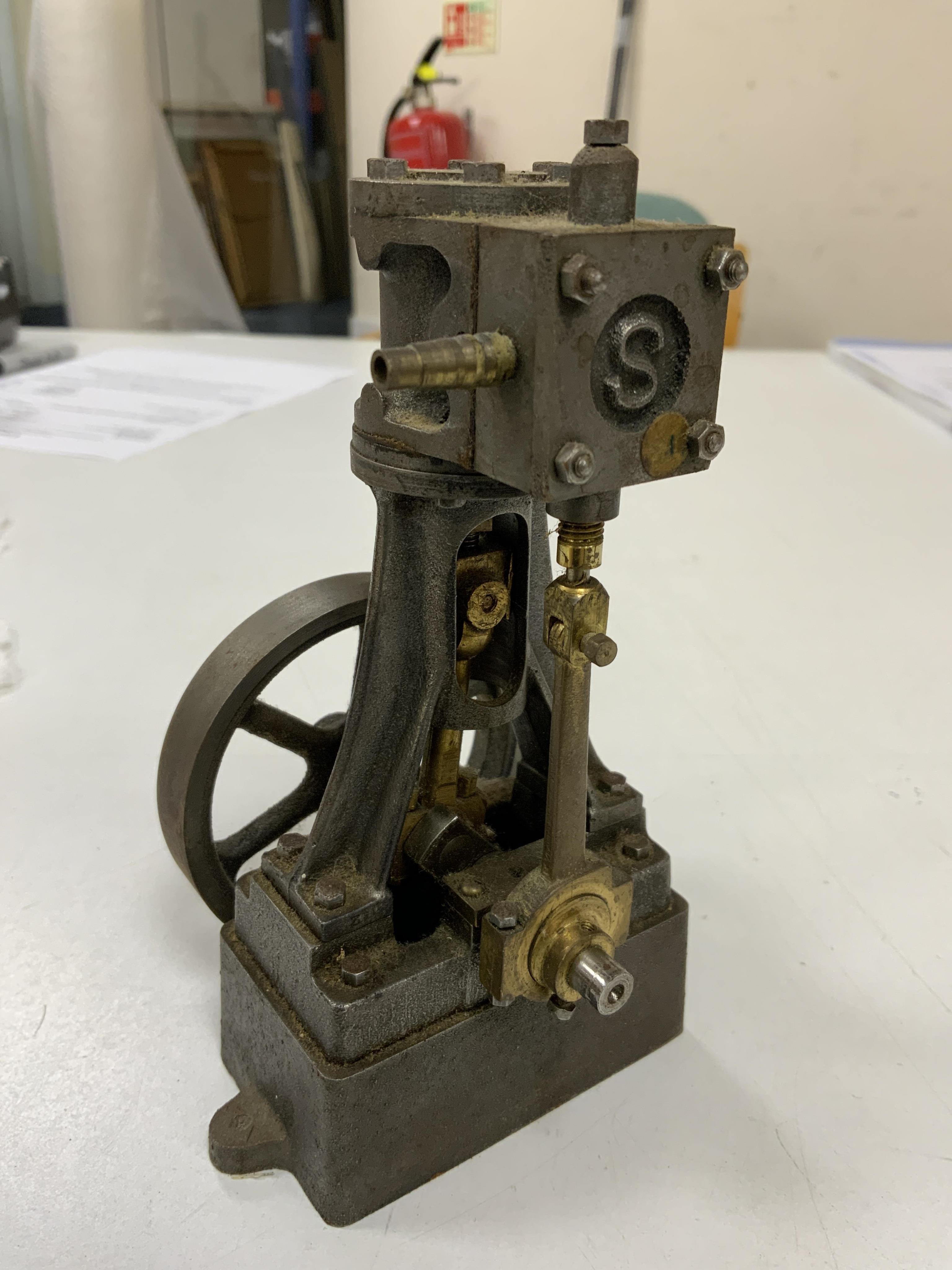 A Stuart No.10 vertical live steam single cylinder stationary engine, together with the original instruction booklets, a book on Sterling engines, and a quantity of useful ferrous and non-ferrous rods